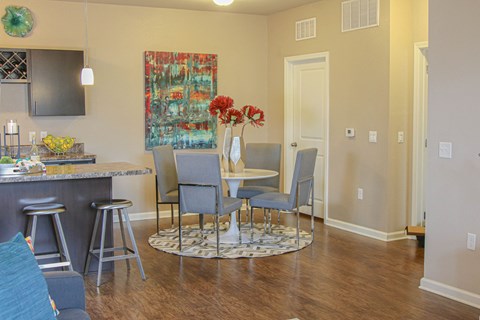 a living room with a dining room table and a kitchen